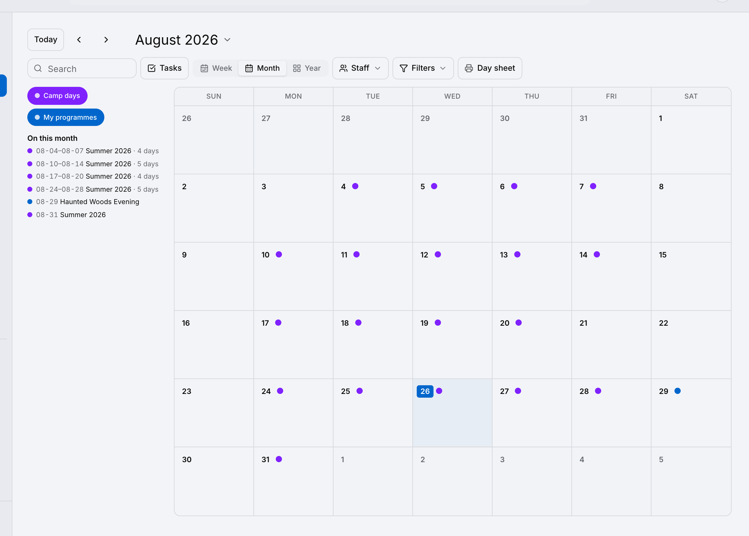 A month calendar for a camp, with a dot on every camp day and the month’s sessions listed beside it.