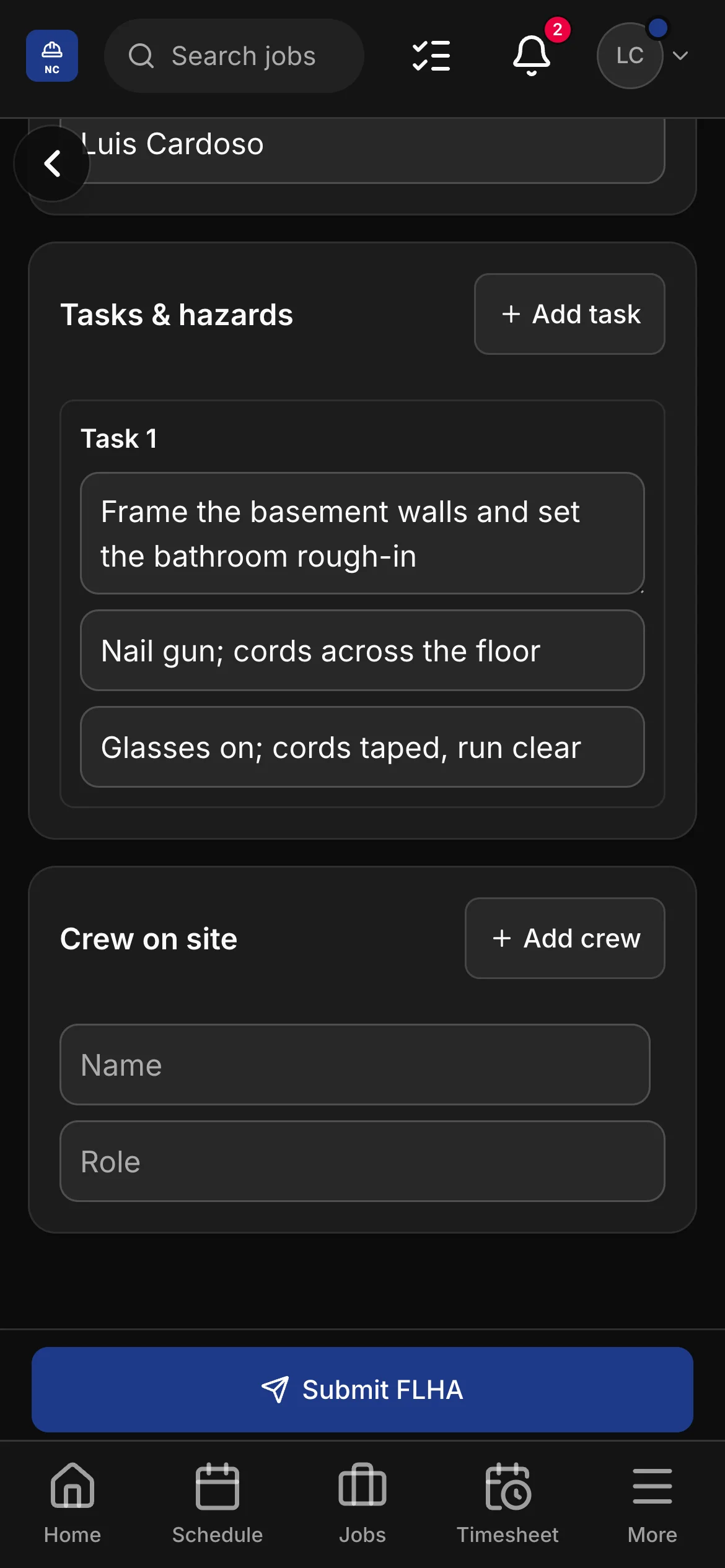 An FLHA in the crew app, “Frame the basement walls and set the bathroom rough-in”: the task with its hazard and its control, and the crew on site under it.