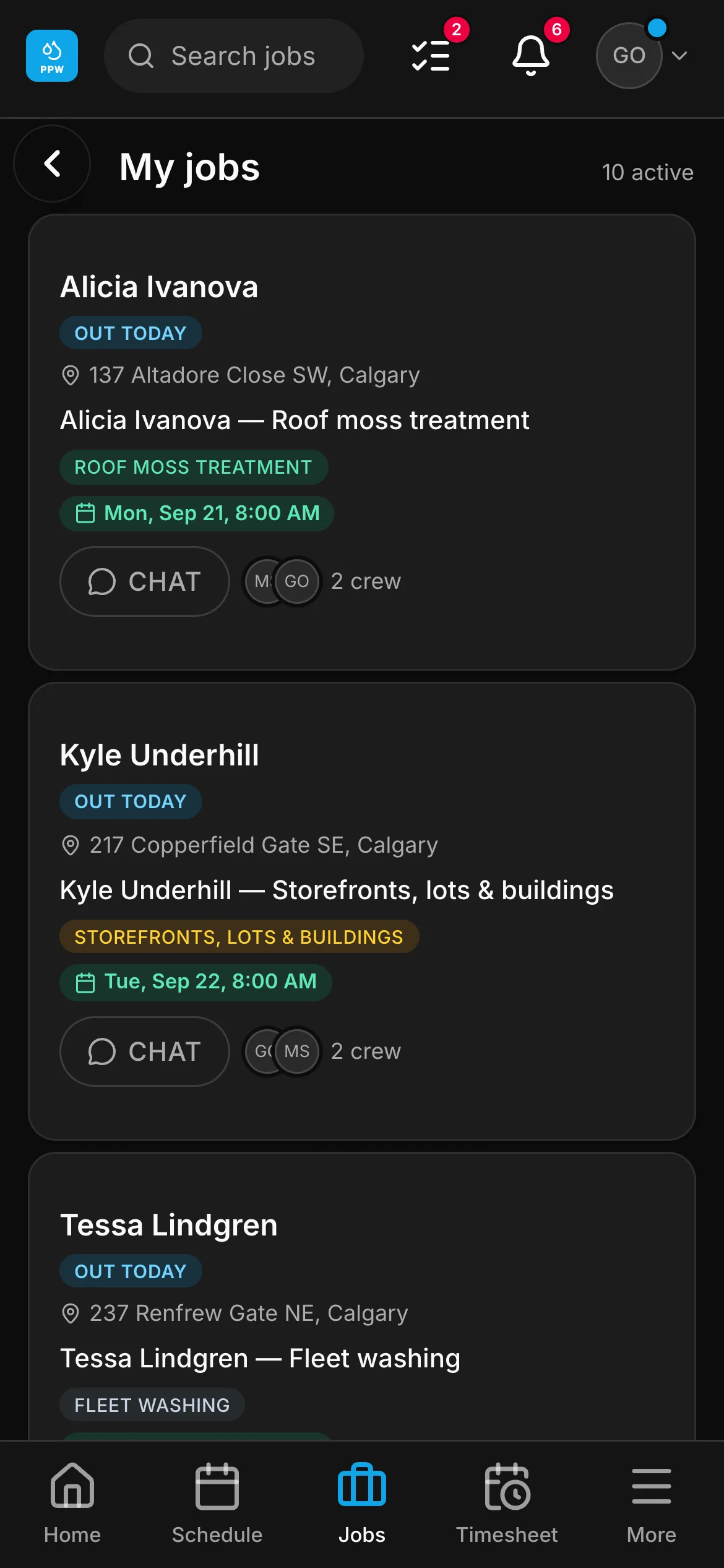 A crew member’s list in the crew app, 10 active: “Alicia Ivanova — Roof moss treatment” and “Kyle Underhill — Storefronts, lots & buildings” among them, each with its address and its time.