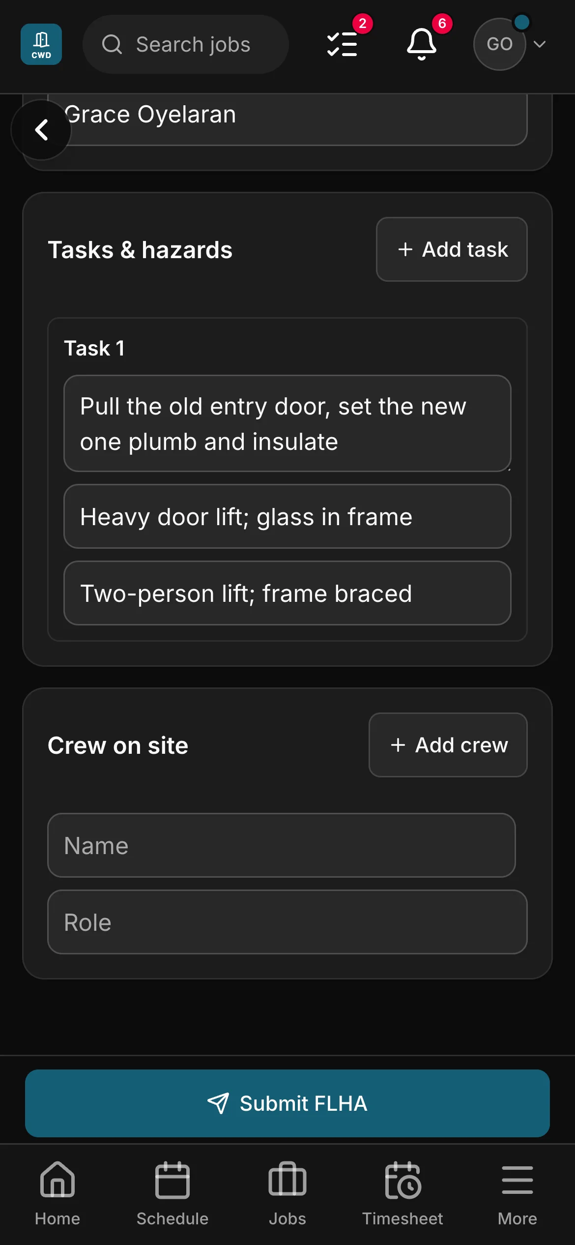 An FLHA in the crew app, “Pull the old entry door, set the new one plumb and insulate”: the task with its hazard and its control, and the crew on site under it.